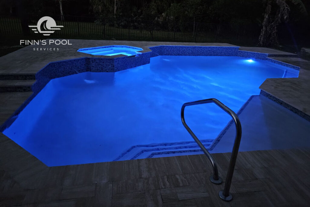 Pool lights illuminating a swimming pool at night for safety and visibility
