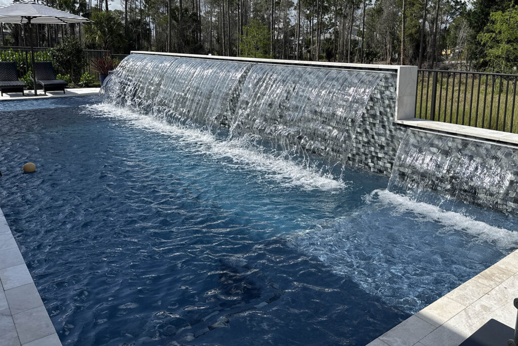 Raised beam pool with scuppers and modern water feature design
