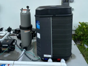 Pool heat pump installed on residential pool equipment pad in Palm Beach County, Florida.