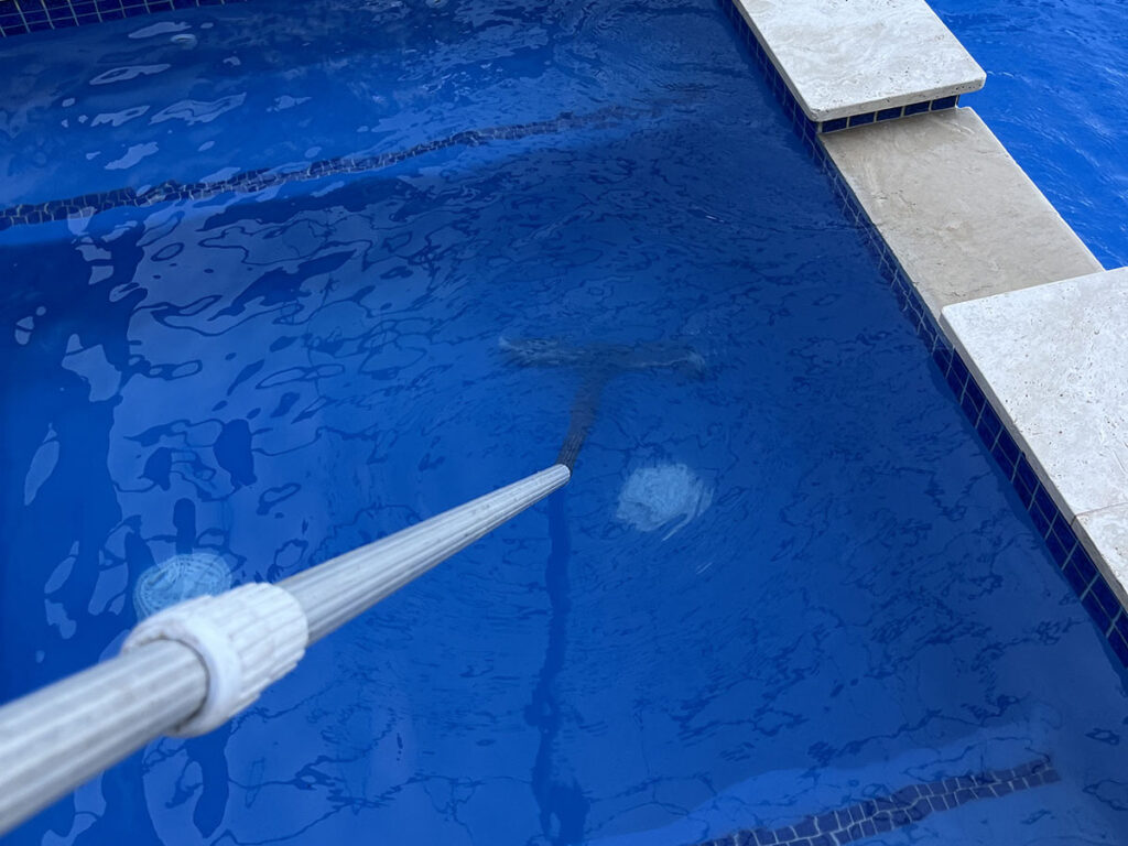 Professional pool cleaning service in Jupiter, FL with routine brushing