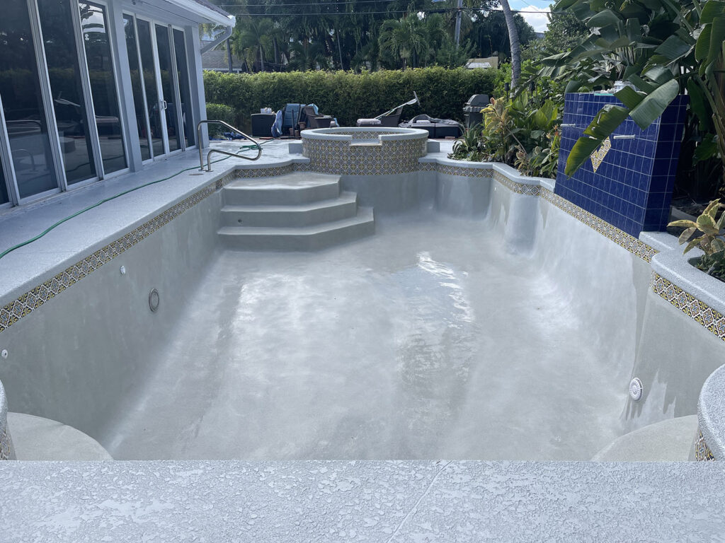 Pool resurfacing in Palm Beach Gardens with a newly finished pool shell and updated steps