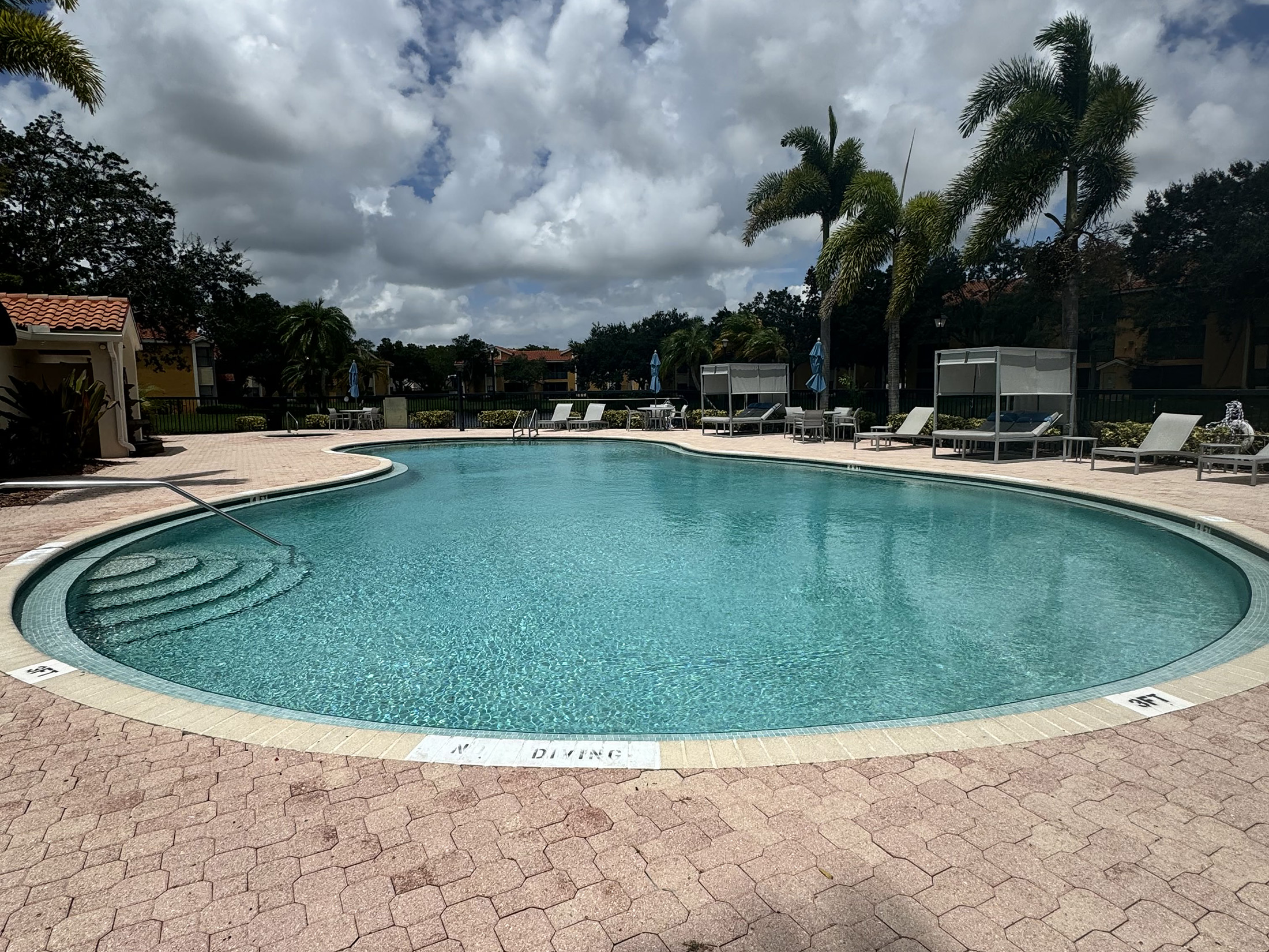 Clean residential pool after maintenance showing clear water and smooth surfaces — avoiding the hidden costs of ignoring pool maintenance