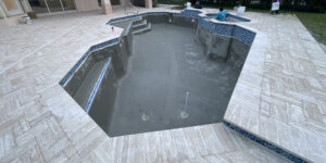 Signs you need pool resurfacing shown in a freshly resurfaced empty swimming pool with smooth, clean surfaces