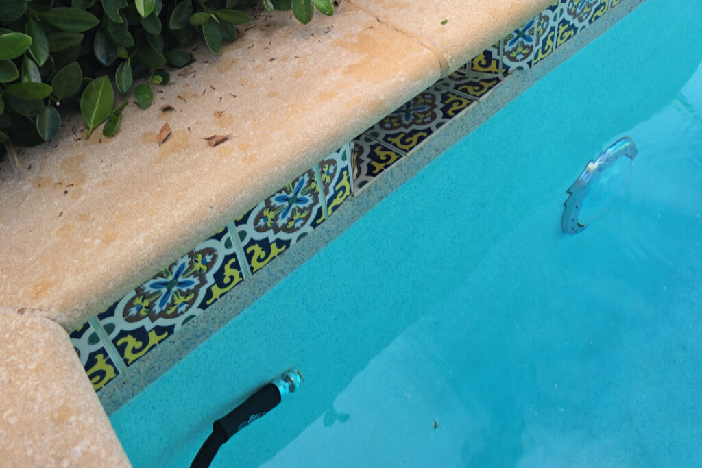 Pool hose refilling water frequently – a common symptom of pool water loss that calls for emergency pool leak detection.