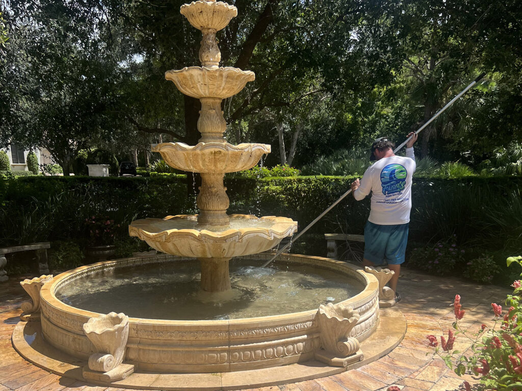 Licensed pool repair technician servicing a residential fountain in West Palm Beach