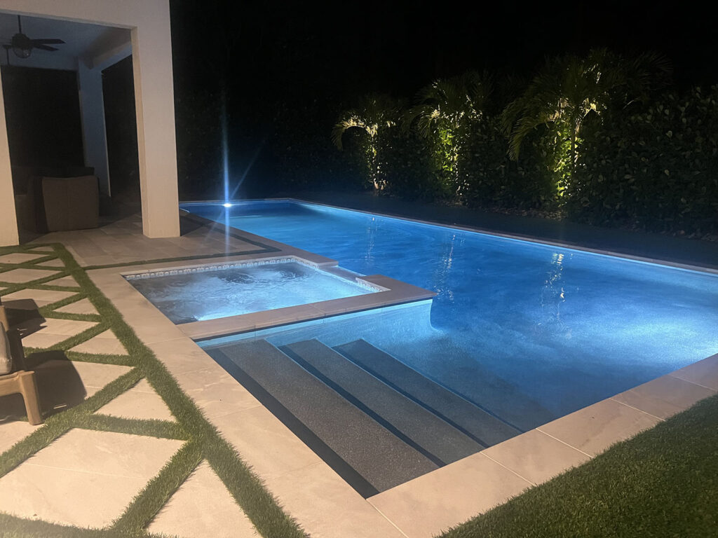 Modern pool remodeling project in Jupiter, FL with upgraded steps, spa, and lighting
