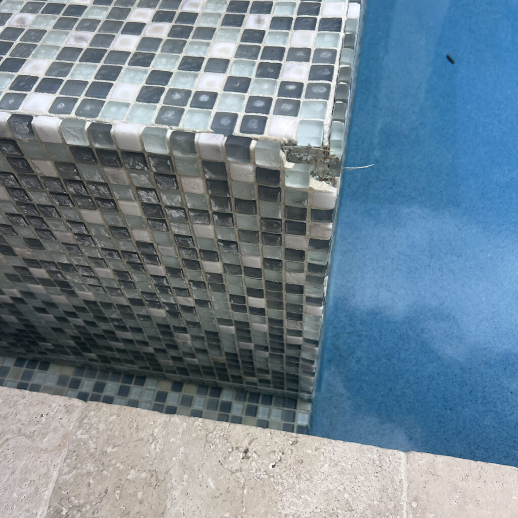 Pool repair in Palm Beach Gardens showing damaged pool tile and surface wear requiring professional repair