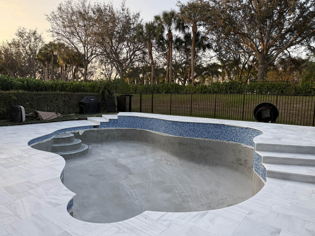Filename: pool-resurfacing-cost-prep-phase-palm-beach.jpg Alt Text: Empty residential pool during preparation phase showing structural work that affects pool resurfacing cost Image Title: Pool Resurfacing Preparation in Palm Beach County