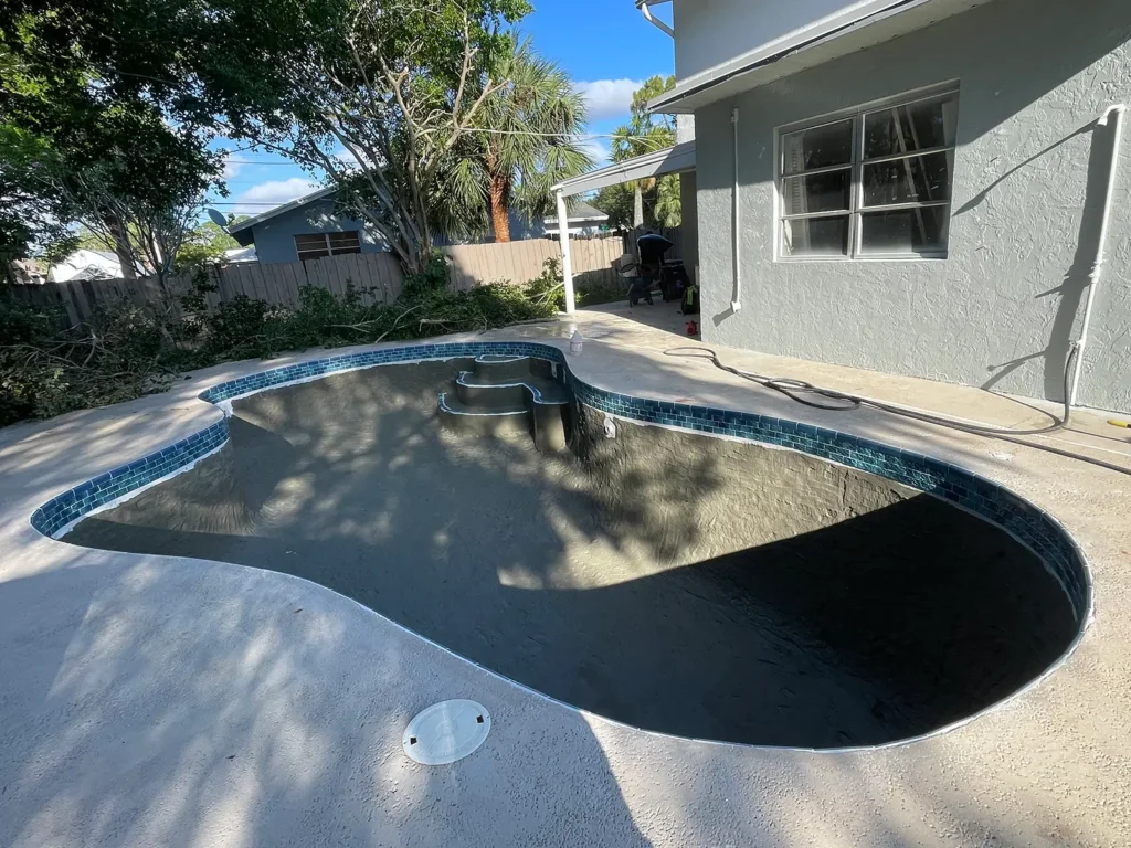 Drained pool showing surface preparation before resurfacing in West Palm Beach.