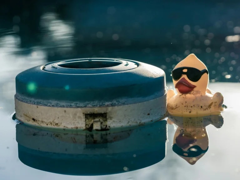 Floating chlorine dispenser in a swimming pool during hot summer weather